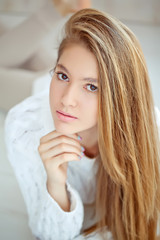 Young girl are posing in sweater at home