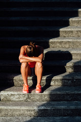 Frustrated sporty woman suffering overtraining. Sport and fitness despair and frustration concept.