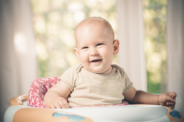 smiling baby boy in the baby walker