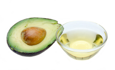 Avocado oil in bowl on white background