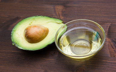 Avocado oil in bowl on wooden table