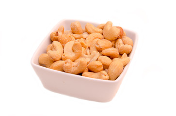 Cashew nuts on bowl on white background