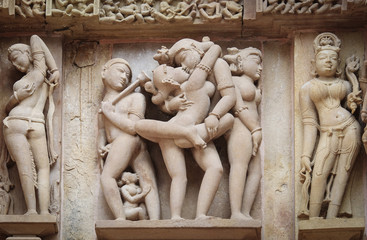 Stone carved erotic bas-relief in Hindu temple in Khajuraho, Ind