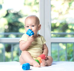 baby boy playing with colorful toy