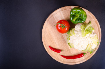 Organic  cauliflower and paprika on wooden background