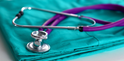 A stethoscope shaping a heart and a clipboard on a medical