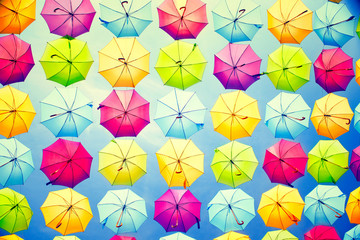 Fototapeta na wymiar Hanging multicolored umbrellas over blue sky