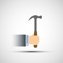 Hand holding a hammer.