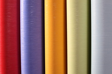 rolls of colored corrugated paper closeup on background 