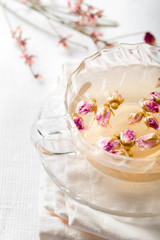 Obraz na płótnie Canvas Rose flower herbal tea in a glass cup