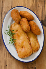 typical portuguese appetizers on white dish on brown background
