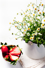 Bunch of camomile flowers with strawberry