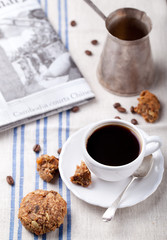 Cup of coffee with cookies and morning newspaper