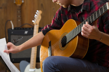 Young man playing acoustic guitar.