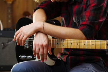 Young man playing electric guitar.