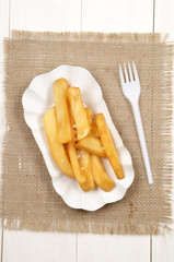french fries on a cardboard dish with a plastic fork