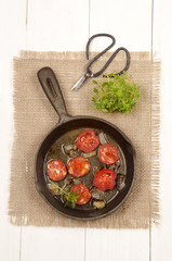 spanish chorizo with tomato and onion in a cast iron pan