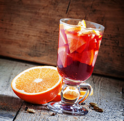 Hot mulled wine with orange and lemon, selective focus