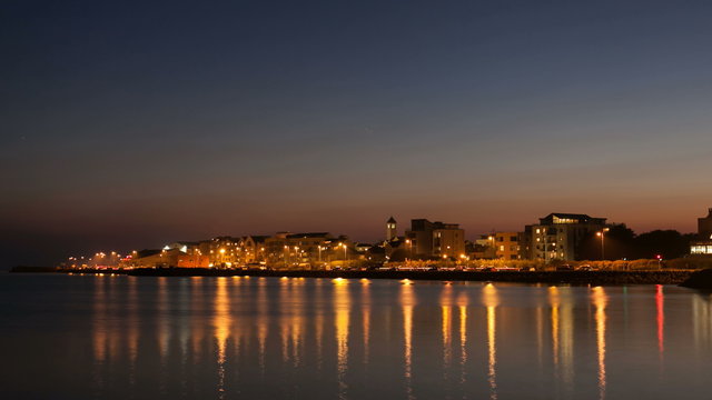 4 K time laps video of the City on the bank of ocean bay and light trails at night. Salthill, Galway. 4096 x 2304