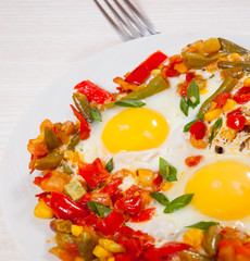 fried eggs with mixed vegetables on plate