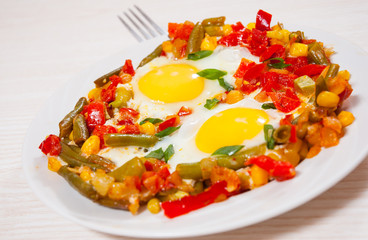 fried eggs with mixed vegetables on plate
