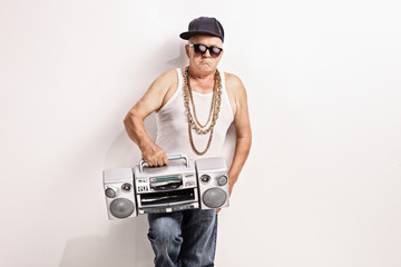 Hardcore senior rapper holding a ghetto blaster