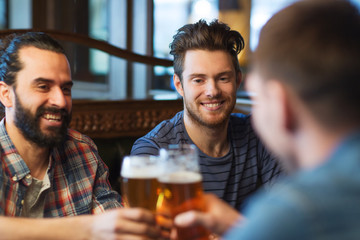happy male friends drinking beer at bar or pub