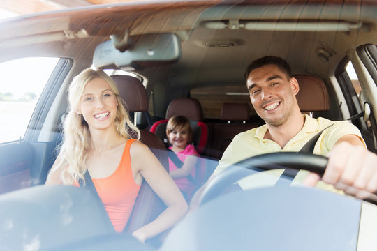 Happy Family With Little Child Driving In Car