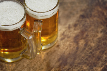 Two cold beer jug on wooden table