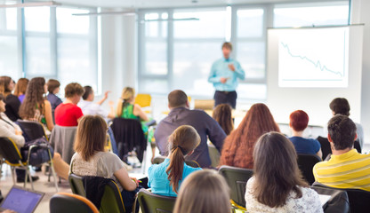 Speaker Giving a Talk at Business Meeting.