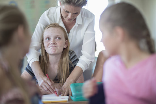 Teacher correcting schoolgirl's bad test