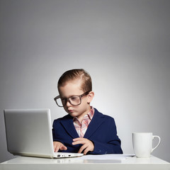 Young boy hacking into the system.funny kid in glasses.little hacker