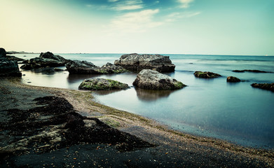 Long exposure shot of rocky coast at sunset