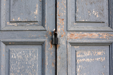 Old grey door closed and locked