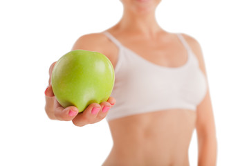 Athletic girl with green apple.