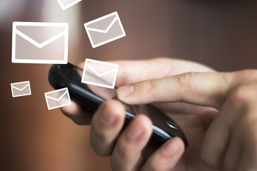 Businessman pushing on cellphone check mail