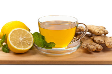 Ginger tea. Ginger, lemon, mint leaves on white background. Selective focus.