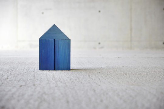 Model house made of building bricks on a construction site