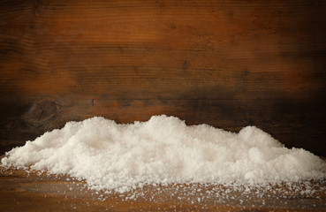 Christmas background with snow over wooden background
