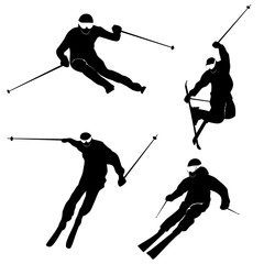 Four silhouettes of skiing persons