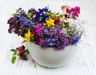 wild flower and herb leaf in mortar