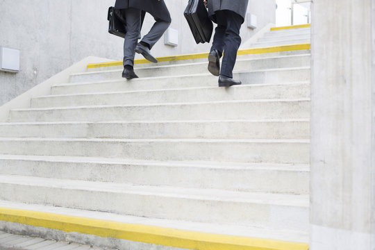 Two businessmen walking on stairs