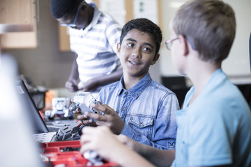 Schoolboys in robotics class talking