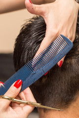 Fototapeta premium men's hair cutting scissors in a beauty salon