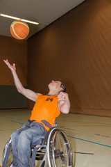 Handicapped boy playing basketball