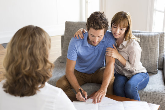Young couple owners meeting real estate agent for investment