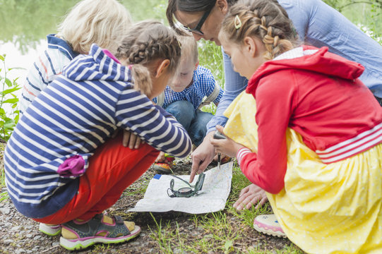 Germany, Children learning how to use compass and map