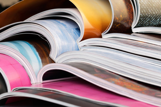 Close-up of stack of colorful magazines