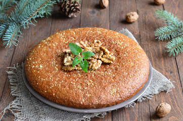 Tasty walnut pie on wooden background