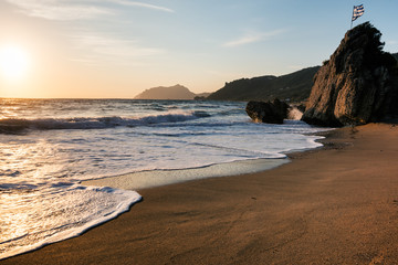  Amazing sandy beach with sea weeds and  clouds, Corfu, Greece.